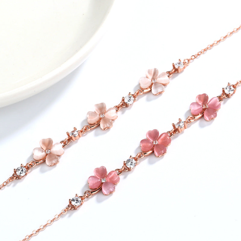 Close-up of Perlevida rose gold flower charm bracelet with sparkling crystal accents