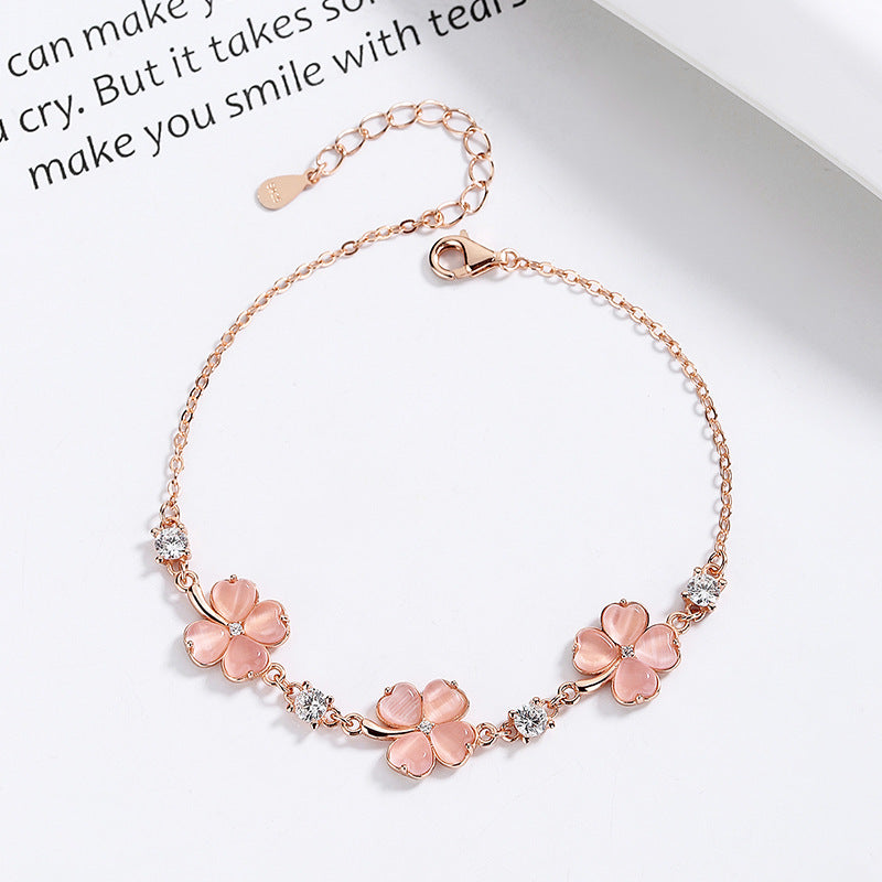 Close-up of Perlevida rose gold flower charm bracelet with sparkling crystal accents