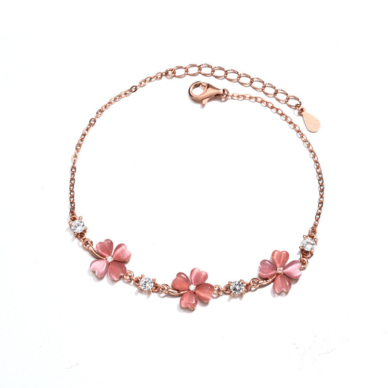 Perlevida floral charm bracelet with white stone flower details and rose gold chain