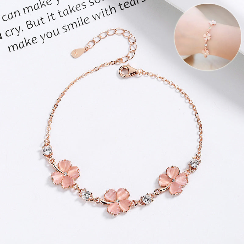 Perlevida flower charm bracelet for women in rose gold with pink stone details
