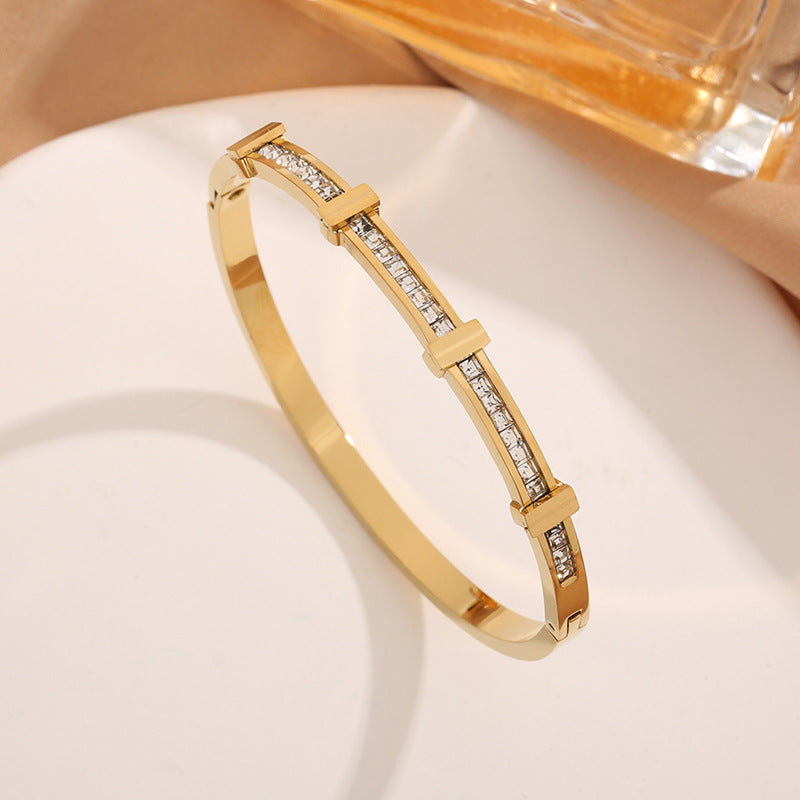 Gold-tone Perlevida rhinestone geometric bangle bracelet